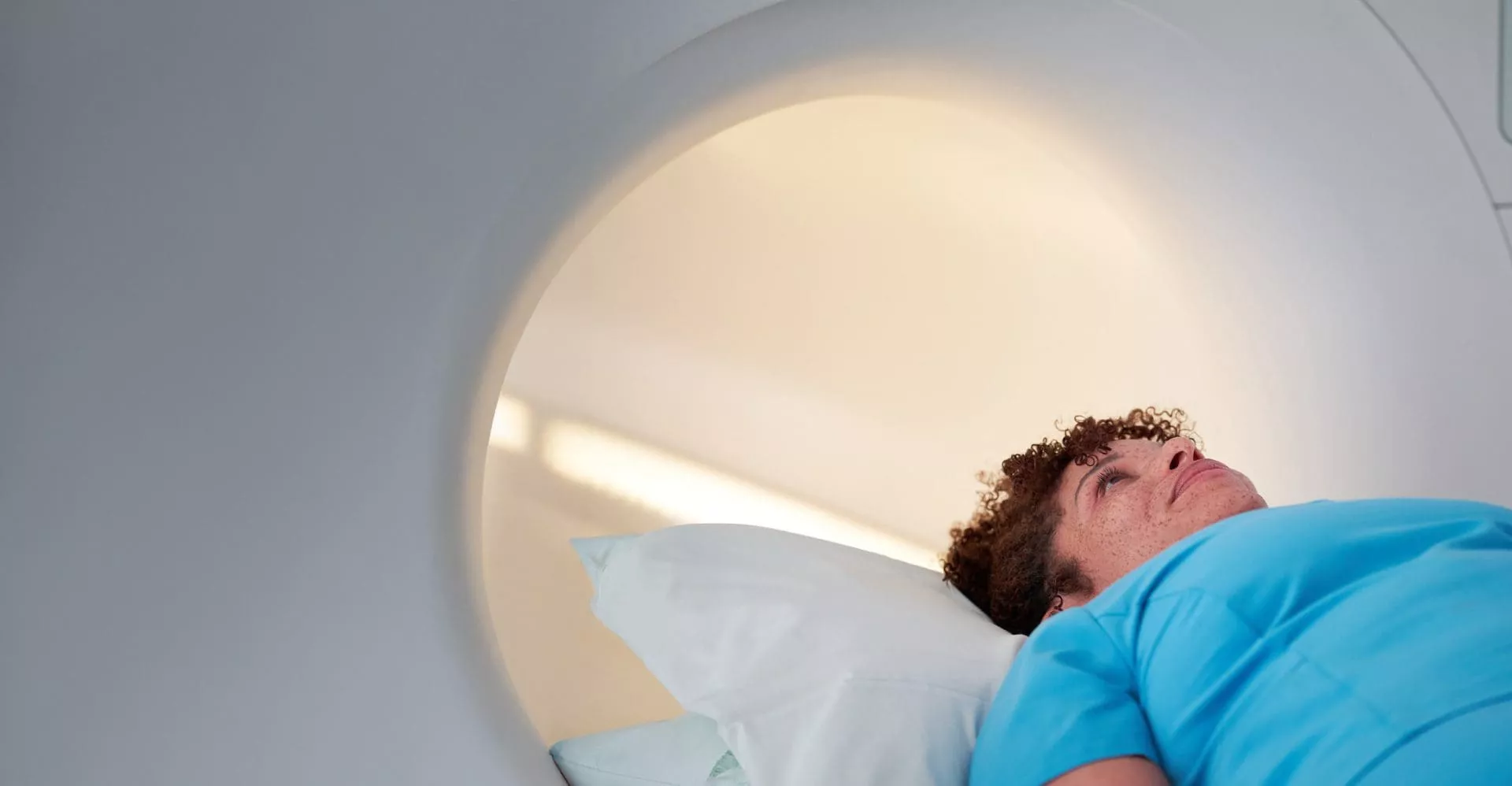 Patient and clinician beside an MRI scanner
